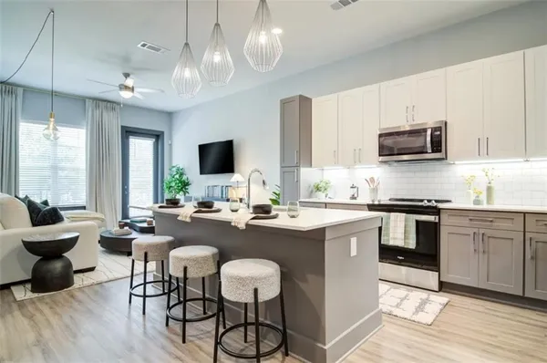 a kitchen with sink cabinets and dining table