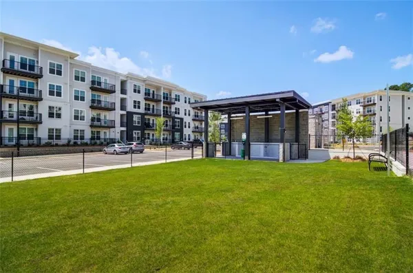 a view of a building with garden and patio