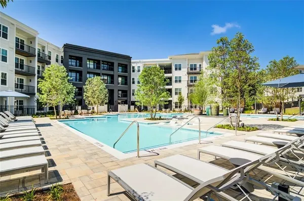 a view of a swimming pool with a lounge chairs