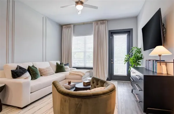 a living room with furniture and a potted plant