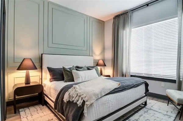 a bedroom with bed and a window