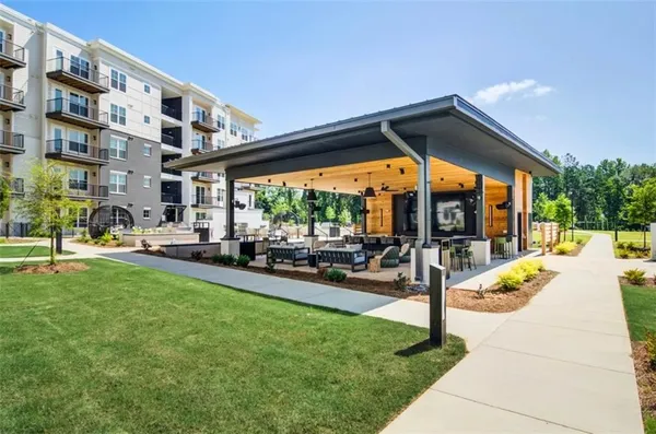 a view of swimming pool with a patio and a yard