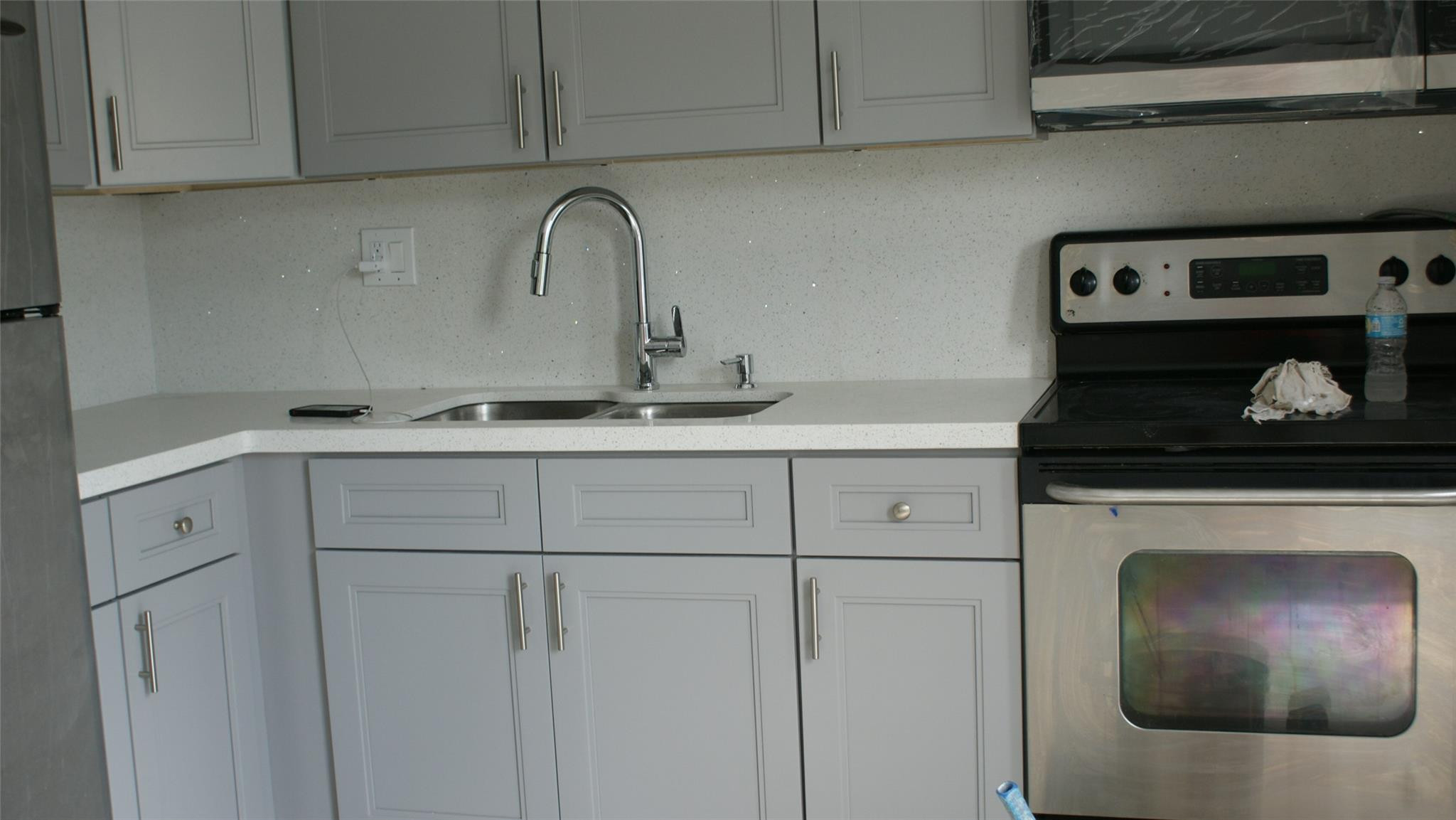 6109 Southwest 30th Street Miramar, FL 33023 - Photo 12 of 22 a kitchen with white cabinets and sink