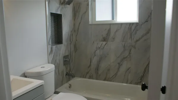 a bathroom with a toilet and shower