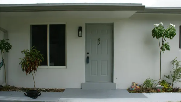a potted plant sitting in front of a door