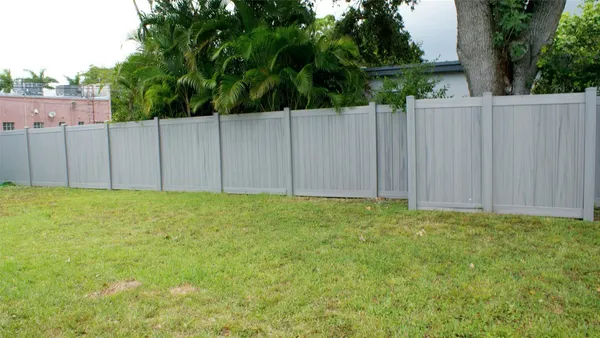 a view of backyard with wooden fence
