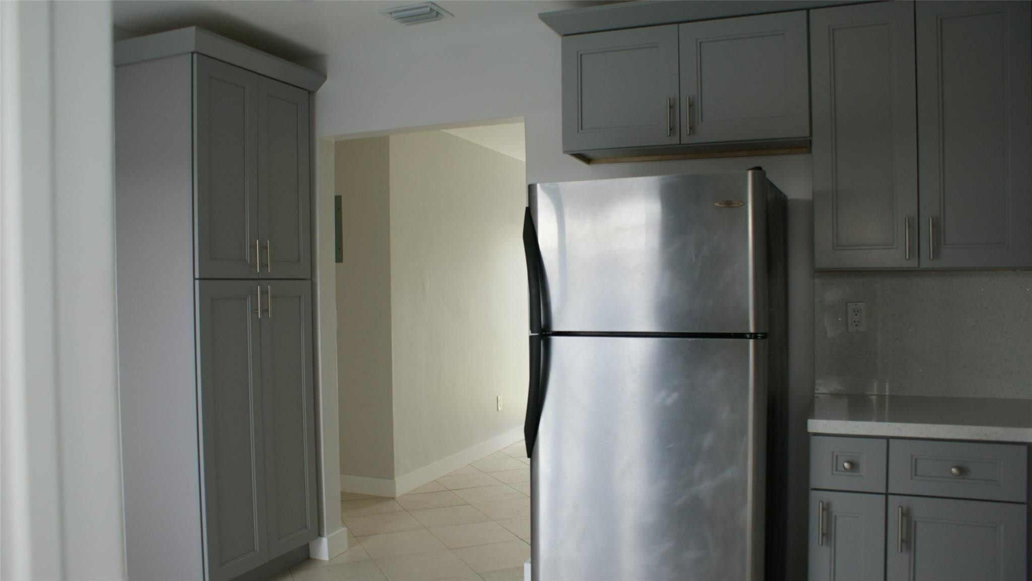 6109 Southwest 30th Street Miramar, FL 33023 - Photo 9 of 22 a view of a refrigerator in kitchen and cabinets