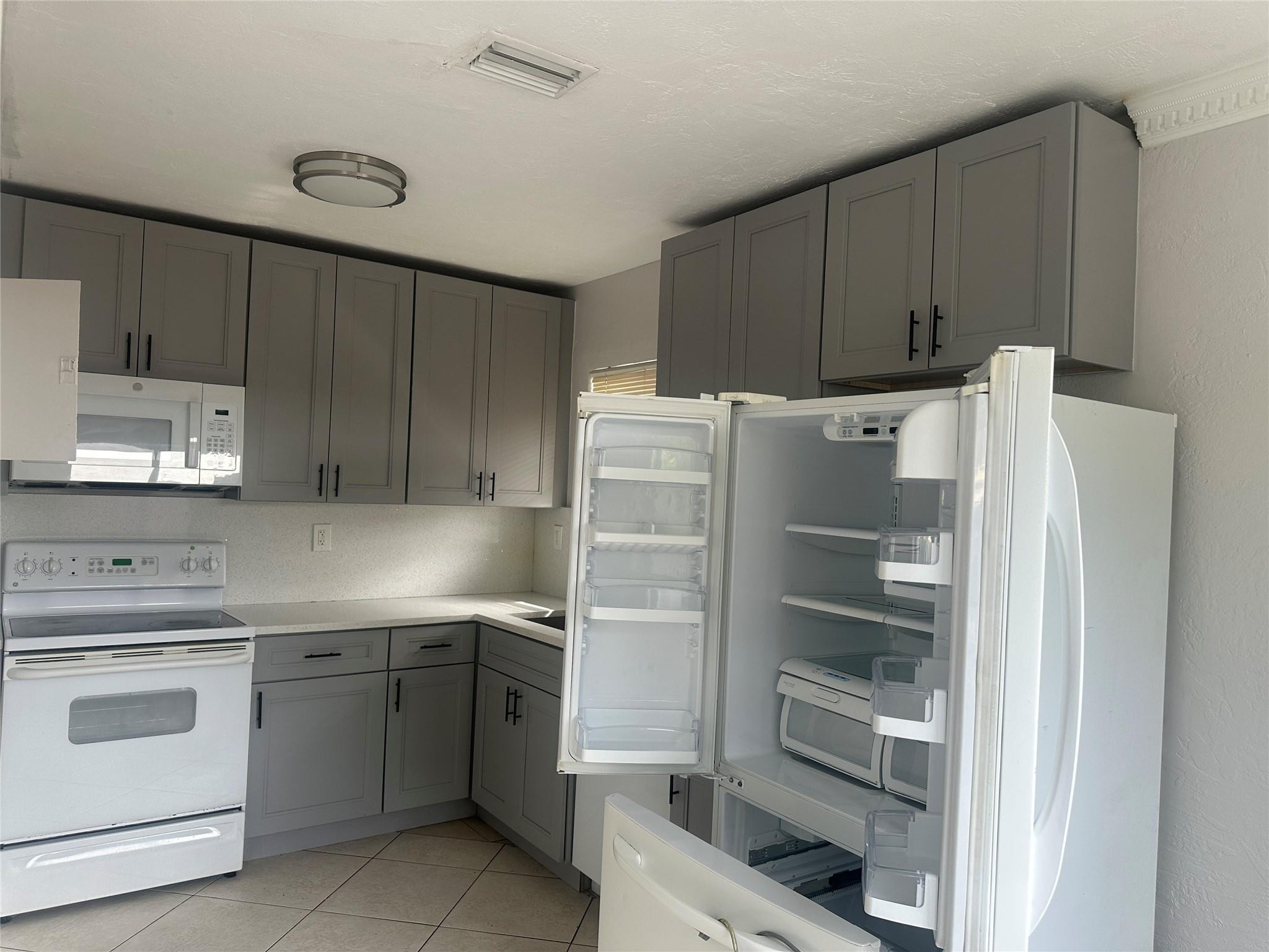 6109 Southwest 30th Street Miramar, FL 33023 - Photo 10 of 22 a kitchen with a cabinets and white appliances