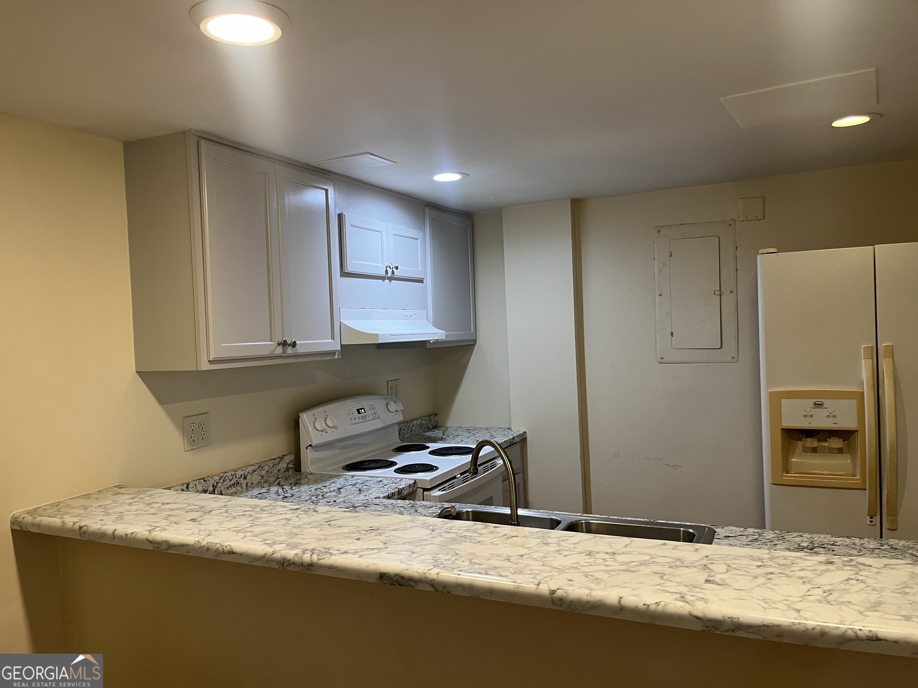 a room with a bed and wooden floor