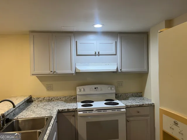 a kitchen with a stove and a sink