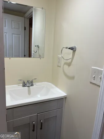 a bathroom with a sink a mirror and vanity