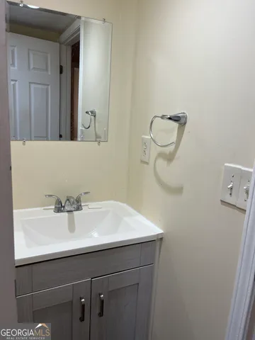 a bathroom with a sink a mirror and vanity