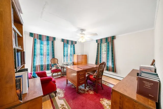 a living room with furniture a large window and a potted plant