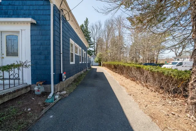 a view of a pathway of a house with wooden fence