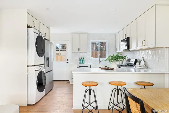 a view of a kitchen with a sink a microwave and cabinets