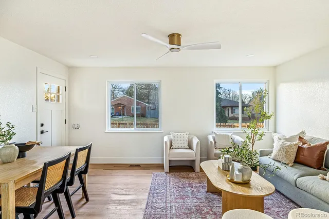 a living room with furniture and wooden floor