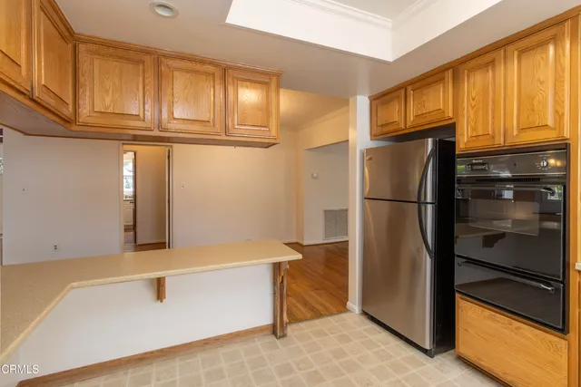 a kitchen with stainless steel appliances granite countertop a refrigerator and cabinets