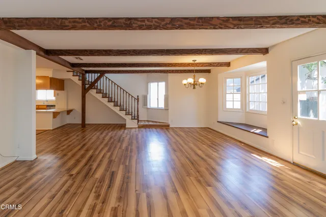 a view of a room with wooden floor and staircase