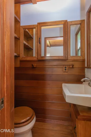 a bathroom with a small sink and a toilet