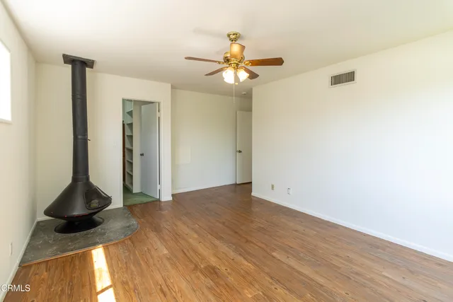 a view of empty room with ceiling fan