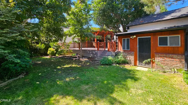 a backyard of a house with yard and outdoor seating