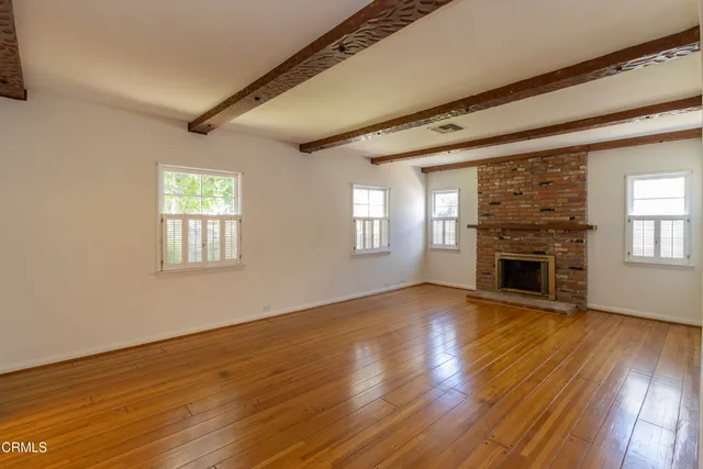 a view of a livingroom with a fireplace and window