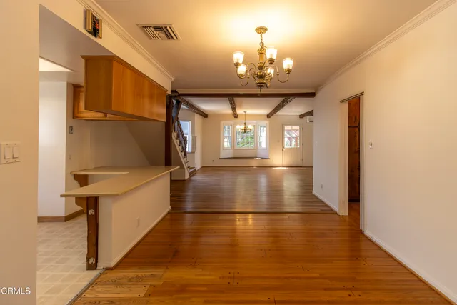 a view of a room with wooden floor