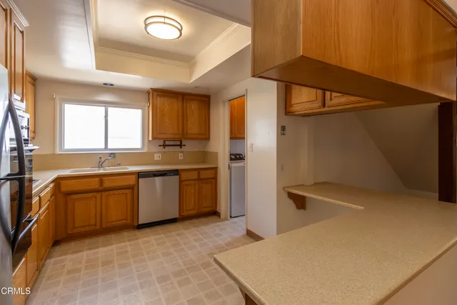 a kitchen with a refrigerator a sink and cabinets