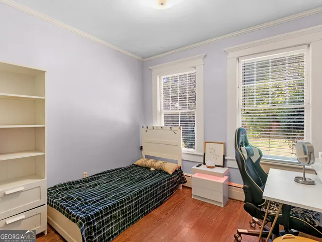 a bedroom with furniture and a window