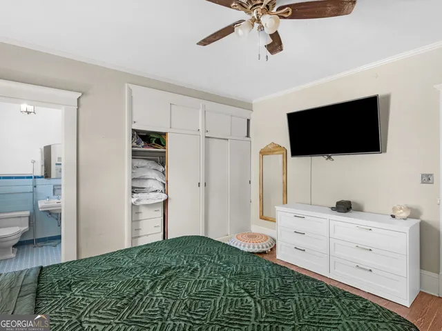 a bedroom with a bed and a flat screen tv