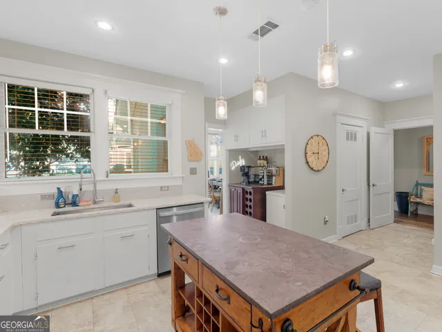 a kitchen with a stove a refrigerator and a sink