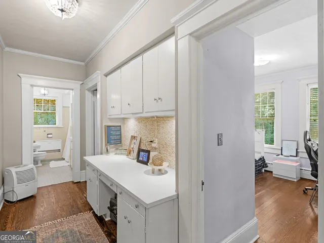 a kitchen with a sink appliances and cabinets