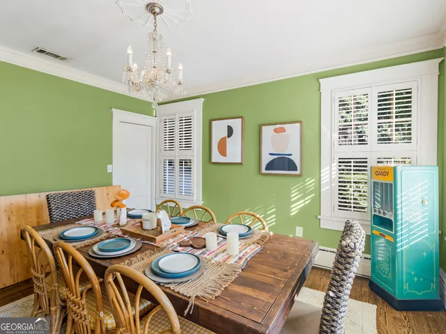 a view of a dining room with furniture and a chandelier
