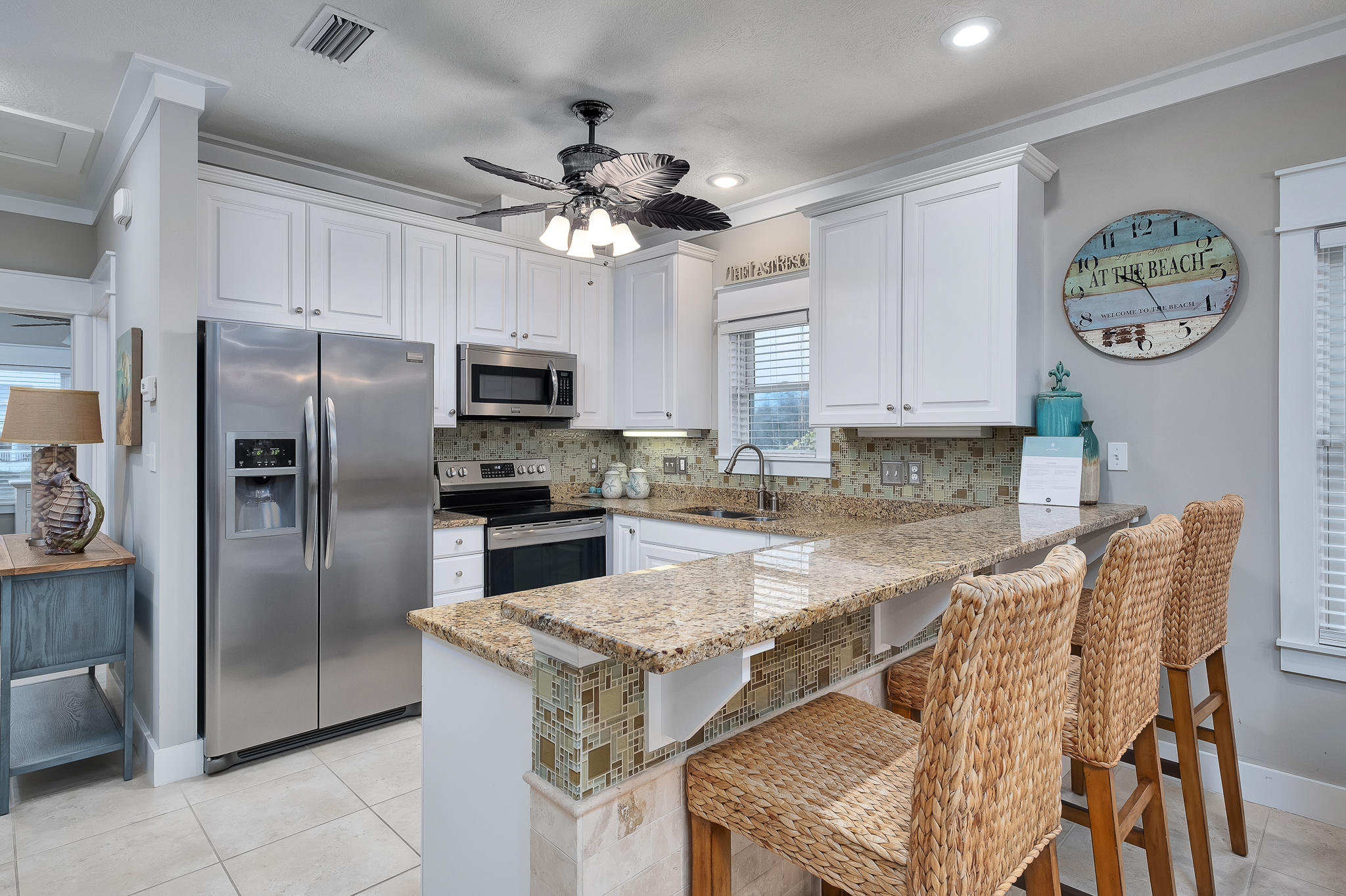 8968 East County Highway 30A Inlet Beach, FL 32461 - Photo 14 of 46 a kitchen with granite countertop a table chairs stainless steel appliances and cabinets