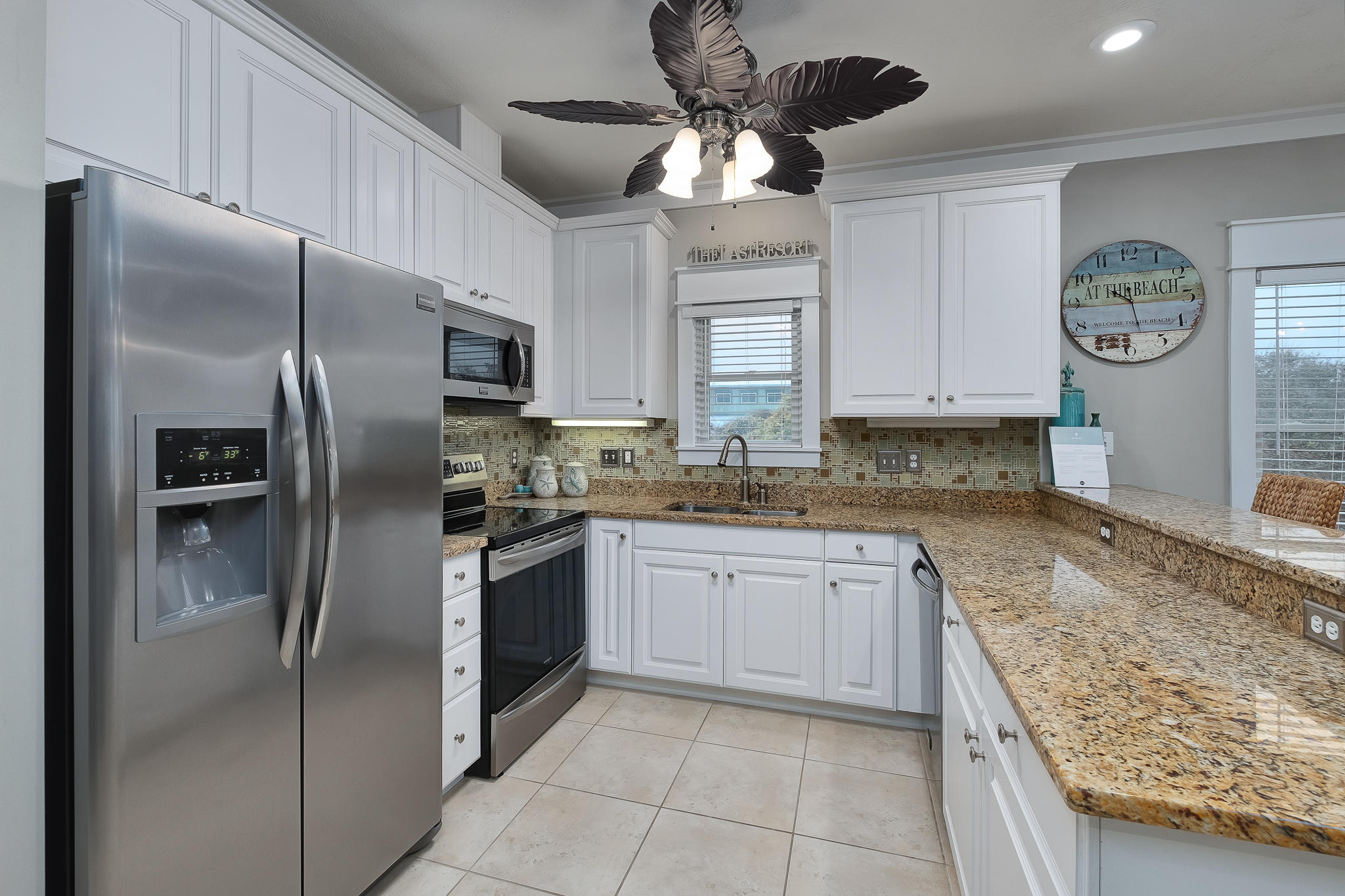 8968 East County Highway 30A Inlet Beach, FL 32461 - Photo 15 of 46 a kitchen with stainless steel appliances granite countertop a refrigerator a sink a stove and cabinets