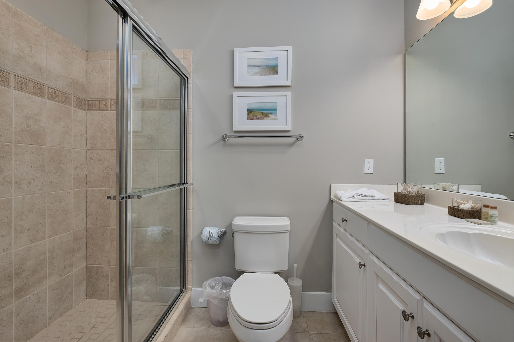 8968 East County Highway 30A Inlet Beach, FL 32461 - Photo 22 of 46 a bathroom with a toilet a sink and glass door