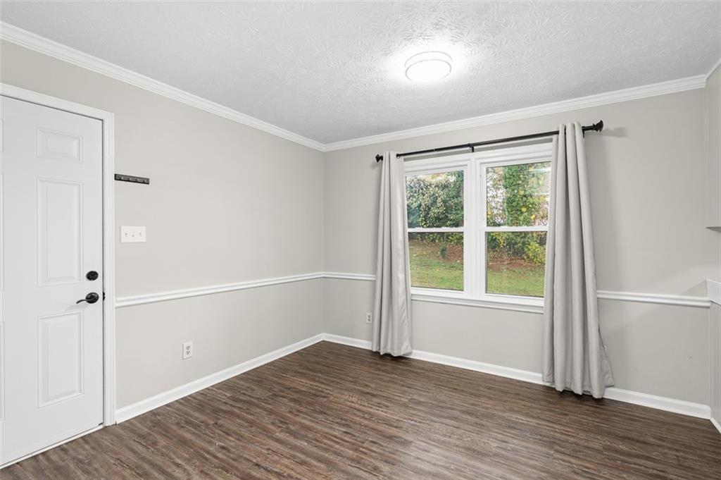 474 Daisy Trail Lawrenceville, GA 30046 - Photo 15 of 41 an empty room with wooden floor and windows