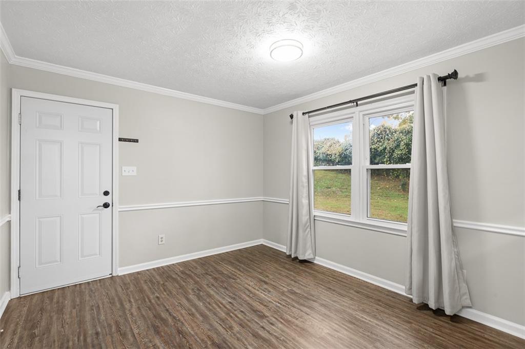474 Daisy Trail Lawrenceville, GA 30046 - Photo 17 of 41 an empty room with wooden floor and windows