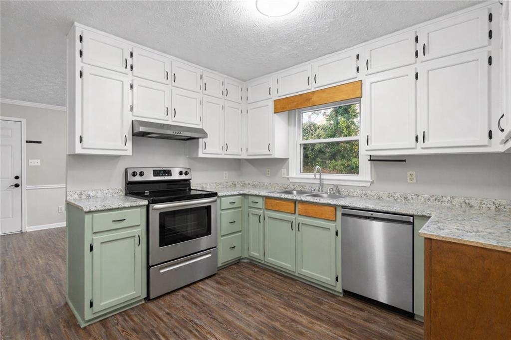 474 Daisy Trail Lawrenceville, GA 30046 - Photo 20 of 41 a kitchen with stainless steel appliances granite countertop a stove a sink and a white cabinets