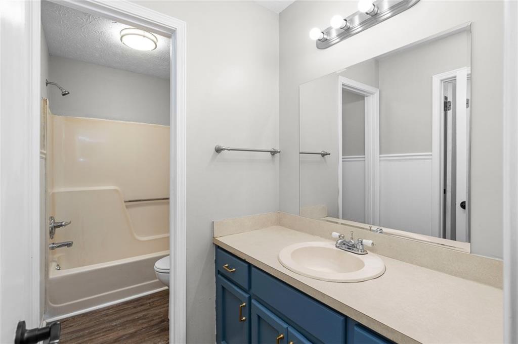 474 Daisy Trail Lawrenceville, GA 30046 - Photo 22 of 41 a bathroom with a granite countertop sink toilet and shower