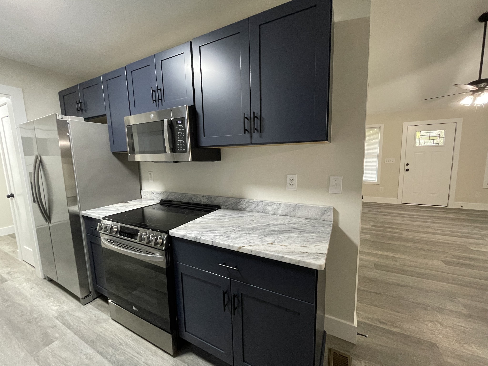 7754 Fernvale Road Fairview, TN 37062 - Photo 14 of 60 a kitchen with stainless steel appliances granite countertop a sink stove and refrigerator