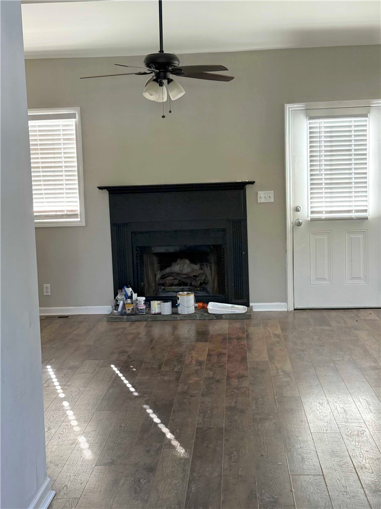 116 Kelly Lane Easley, SC 29642 - Photo 28 of 39 Rich wood-look flooring and a classic fireplace anchor this inviting living space.