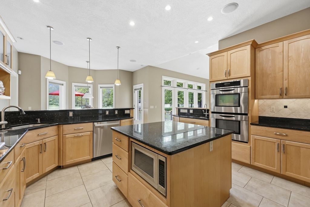 33 Labrie Lane Holyoke, MA 01040 - Photo 10 of 42 a kitchen with stainless steel appliances granite countertop a sink stove and refrigerator