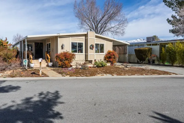 a front view of a house with sitting area