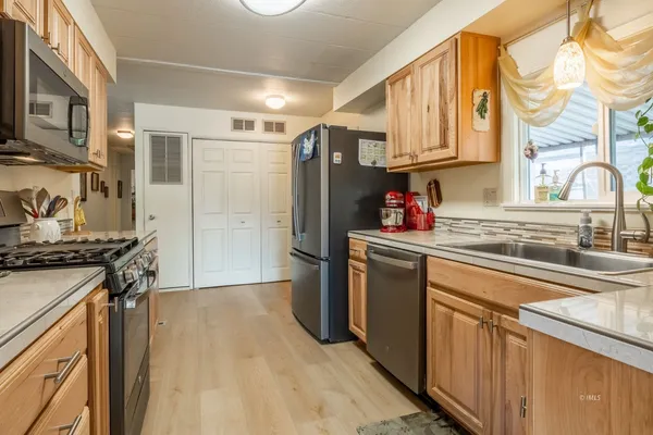 a kitchen with a sink stove and cabinets