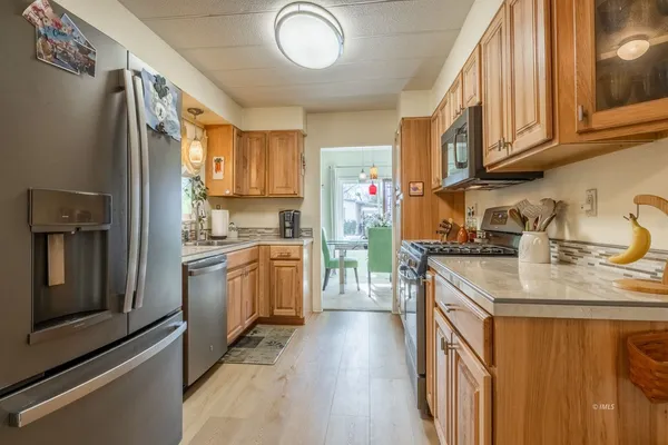 a kitchen with stainless steel appliances granite countertop a stove and a microwave