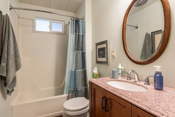 a bedroom with a bed and a painting on the wall