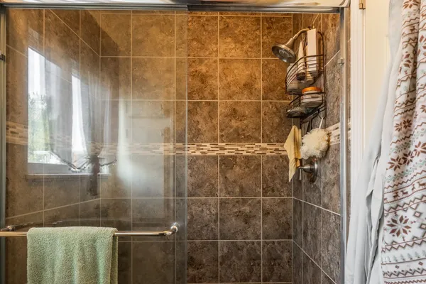 a view of a patio with table and chairs under an umbrella