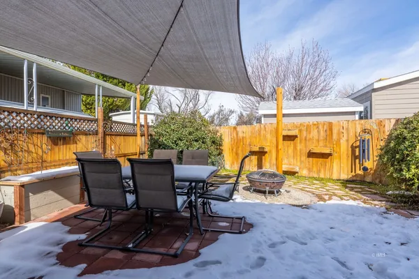 a view of a patio with table and chairs under an umbrella