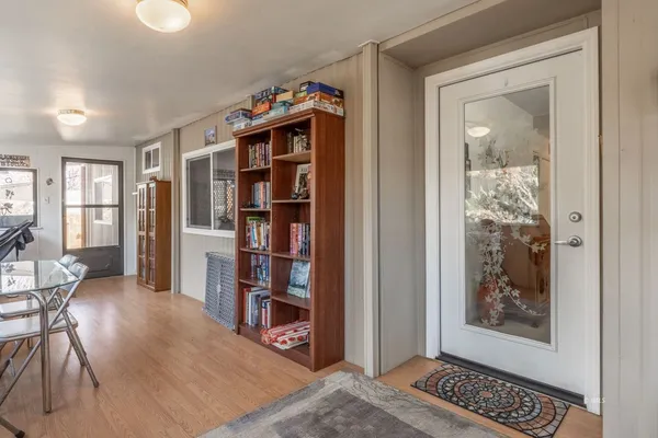 a living room with furniture and a glass door